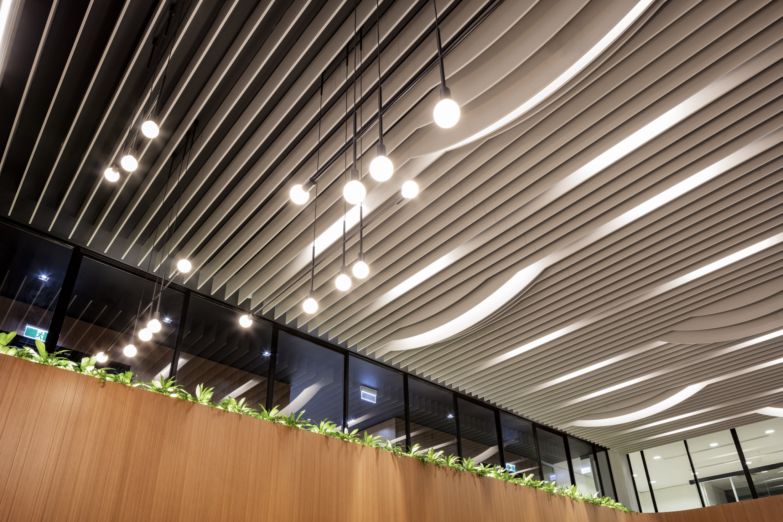 420 St Kilda Rd | Curved linear lights and illuminated timber features elevate this lobby.
