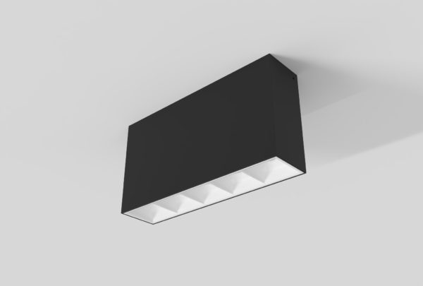 black surface mount rectangular linear light with square segments and white inner trim installed in ceiling